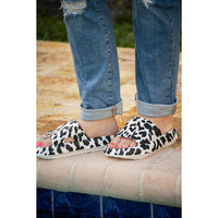 White leopard-print beach slides with a bold spotted pattern and easy slip-on design
