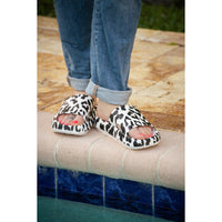 White leopard-print beach slides with a bold spotted pattern and easy slip-on design
